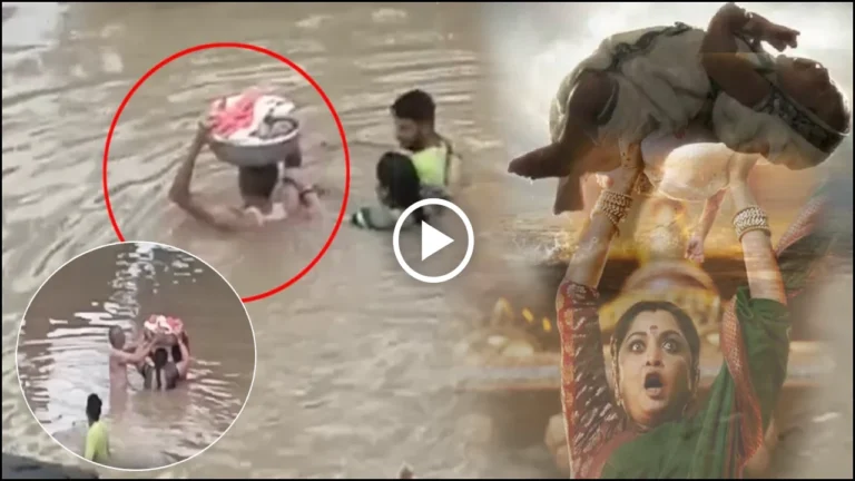 Telangana Rains _ Bahubali Water Scene Repeats in Manthani, a man carries 2 months of old boy in basket in flood, Video Goes Viral